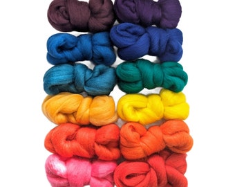 May include: Rainbow coloured wool roving in a rainbow colour gradient. The roving is arranged in a stack of 10 bundles, with each bundle tied in a knot.