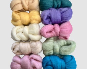 May include: Ten balls of wool yarn in various colours, including green, purple, pink, white, cream, yellow, and blue. The balls are arranged in a stack.