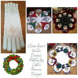 May include: Three felt applique patterns for a winter wreath, table runner, and table topper. Each pattern features a snowman design with red, green, and white accents. The text "Choose from 3 Winter Designs. Patterns by Cath's Pennies Designs" is displayed in the center of the image.