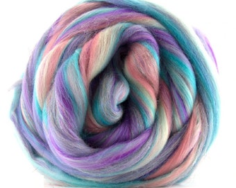 May include: A ball of colourful wool roving in shades of pink, purple, blue, and white. The roving is arranged in a spiral pattern.