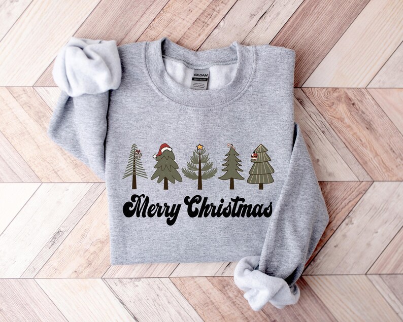 May include: Gray sweatshirt with a graphic of five stylized Christmas trees and the text "Merry Christmas" in a retro font.