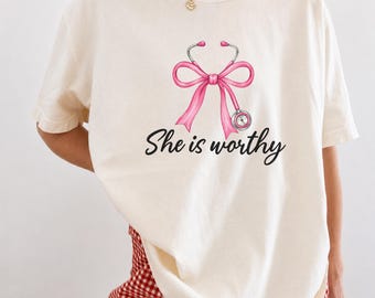 She Is Worthy Nurse Shirt, Pink Bow Stethoscope Graphic Tee, Inspirational Nursing T-Shirt, Cute Healthcare Worker Gift