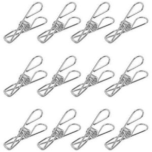 May include: A set of twelve stainless steel clothespins. Each clothespin features a spring-loaded design with a looped handle and a gripping mechanism. The clothespins are arranged in a grid pattern against a white background.