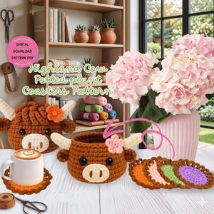 May include: Crocheted Highland cow-themed coasters and a small plant pot. The brown and white cow designs include horns and flower accents. The image also shows a white mug with a latte and a stack of colorful coasters.