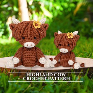 May include: Two crocheted Highland cow plushies in shades of brown, cream, and yellow, sitting on a wooden slice. The cows have fluffy brown hair, cream-colored horns and feet, and yellow flower accents. The text "HIGHLAND COW CROCHET PATTERN" is at the bottom.
