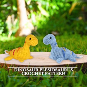 May include: Two crocheted dinosaur toys, one yellow with red stripes and the other blue with yellow stripes, are displayed on a wooden surface. The text "DINOSAUR PLESIOSAURUS CROCHET PATTERN" is visible below the toys.