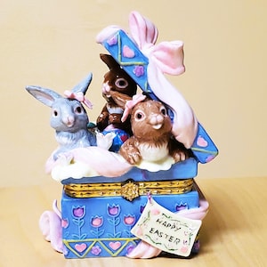 May include: A set of three ceramic mugs with a speckled, matte finish. The mugs are in shades of cream, light gray, and dark gray. Each mug has a simple, minimalist design, perfect for coffee or tea.