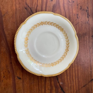 A Castleton USA 'Laurel' pattern ceramic plate with gold trim.
