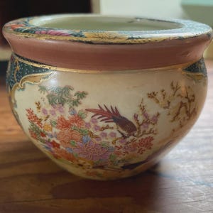 Vintage Chinese porcelain fish bowl with floral and bird decoration.