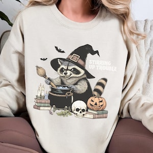 Stirring Trouble Halloween Cute Raccoon Sweatshirt | Cottagecore Fall Sweater, Oversized Raccoon Pullover, Vintage Halloween, Raccoon Autumn