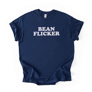 May include: Navy blue t-shirt with the white text "BEAN FLICKER" across the chest. The shirt has short sleeves and a crew neck. The fabric is soft and appears to be cotton.