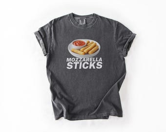 May include: A dark gray t-shirt with a white graphic of mozzarella sticks and marinara sauce. The text "MOZZARELLA STICKS" is printed in white below the image.