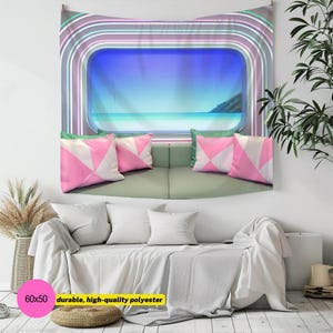 May include: A wall tapestry featuring a rectangular window view of a blue ocean and sky, framed by concentric neon-style arches in purple, white, and teal. Below the window, four pink and white geometric pillows rest on a light green sofa.