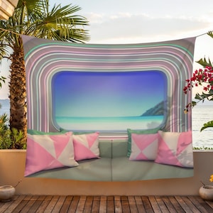May include: A rectangular wall tapestry featuring a central window-like view of a calm turquoise ocean and sky. The frame consists of concentric pastel-colored stripes in shades of pink, teal, and grey. Four pillows with pink and white geometric patterns are arranged along the bottom edge of the design.
