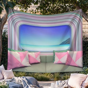May include: A wall tapestry featuring a central rectangular window view of a calm blue ocean and sky, framed by concentric pastel-colored stripes in shades of pink, teal, and gray, with a printed graphic of a sofa and pink geometric pillows.