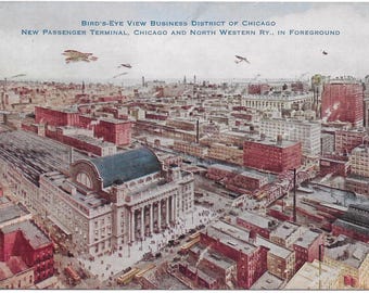 May include: Vintage postcard featuring a bird's-eye view of the Chicago business district. The image showcases the New Passenger Terminal of the Chicago and North Western Railway. The postcard has text at the top and depicts buildings and airplanes.