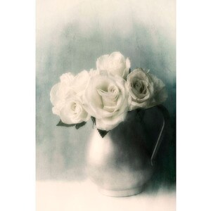 May include: A bouquet of white roses in a silver pitcher against a blue and green watercolor background.