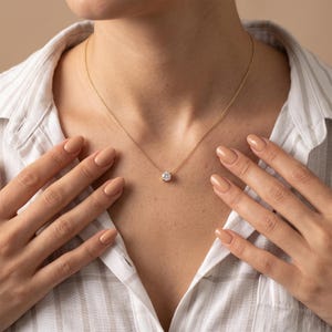 Minimalist gold diamond necklace styled as elegant bridal jewelry for weddings and special occasions.