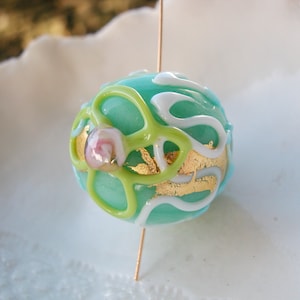 May include: A handmade wooden sign with the text "Welcome" in a handwritten style. The sign is painted white with a distressed finish, and a small green leaf is attached to the top. The sign is designed for indoor or outdoor use.