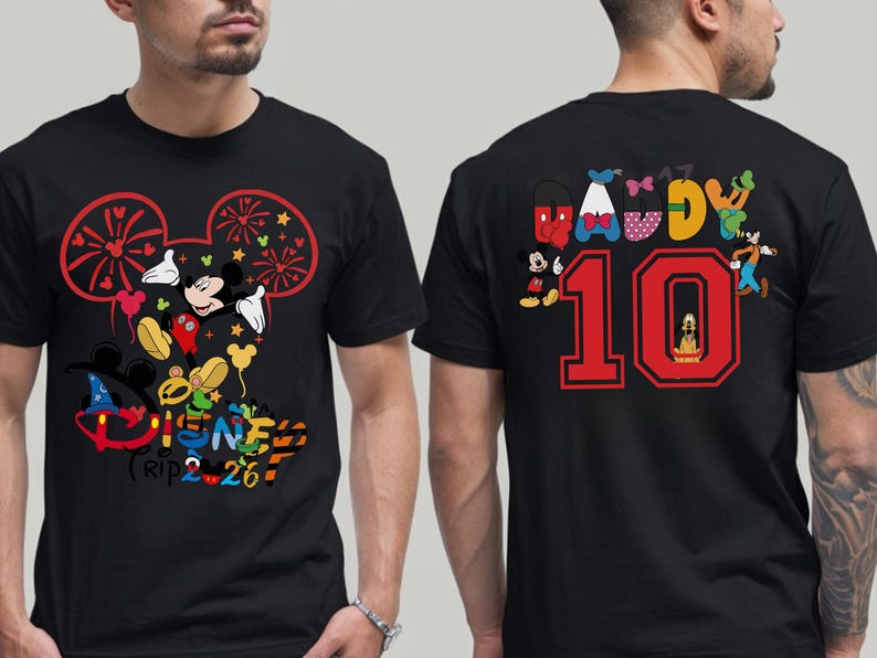May include: Black t-shirt with a vibrant Disney-themed design. The front features Mickey Mouse and friends, with the text "Disney Trip 2-26". The back displays "Daddy 10" with Disney characters. A fun, themed apparel item.