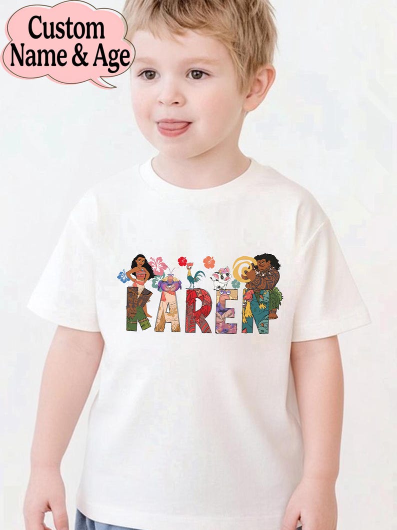 May include: White t-shirt with the name "KAREN" in colorful letters, featuring cartoon characters. The shirt has a custom name and age bubble in the upper left corner.