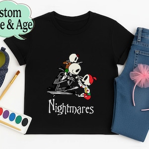 May include: Black t-shirt with a graphic of Jack Skellington and Sally from The Nightmare Before Christmas, with the word "Nightmares" in white. Includes blue jeans, a pink headband, and a pair of blue shoes.
