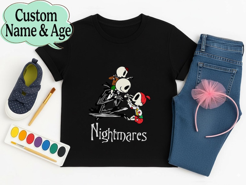 May include: Black t-shirt with a graphic of Jack Skellington and Sally from The Nightmare Before Christmas, with the word "Nightmares" in white. Includes blue jeans, a pink headband, and a pair of blue shoes.