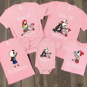 May include: Pink t-shirts and a onesie featuring characters from The Nightmare Before Christmas. The shirts have the phrases "Mother Of Nightmares", "Father Of Nightmares", "Big Nightmares", and "Little Nightmares". The onesie says "Nightmares".