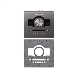 May include: A dark gray audio interface with the text "apollo twin | x" above a large silver knob. Below the interface is a gray felt pad with a cutout matching the interface shape and the text "MA 81" at the bottom.
