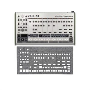 May include: Silver and white RD-9 Rhythm Designer with numerous knobs, buttons, and sliders. The text "RD-9" and "RHYTHM DESIGNER" are visible. A gray felt cover with cutouts for the controls is below the device.