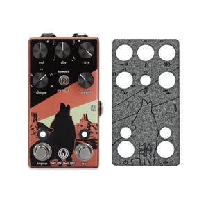 May include: A red and black guitar pedal with a wolf graphic and the text "MONUMENT" on the front. The pedal has knobs labeled "vol", "div", "rate", "shape", "depth", and "harmonic". It also has two footswitches labeled "bypass" and "tap".