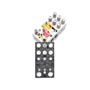 May include: A black and gray felt pedalboard template with a variety of circular cutouts. The template is designed to fit a pedalboard with a specific layout. The template is labeled with the words "Reverse Mode" and "C".