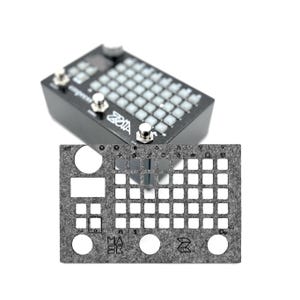 May include: A gray felt pad with cutouts for a keyboard, labeled with letters and symbols. The pad has the text "MASK" and a stylized "Z" logo.