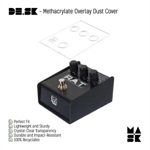 May include: A black Pro Co Rat pedal with a clear plastic dust cover. The pedal has four knobs labeled "Filter", "Distortion", "Tone", and "Volume". The dust cover has four holes for the knobs.