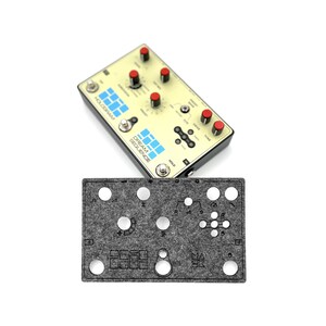 May include: A gray felt template for a HOLOGRAM DREAM SEQUENCE pedal. The template has cutouts for knobs, buttons, and a footswitch. The template is designed to be used with a pedalboard.