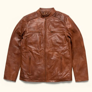 May include: A brown leather jacket with a zip fastening and multiple pockets.