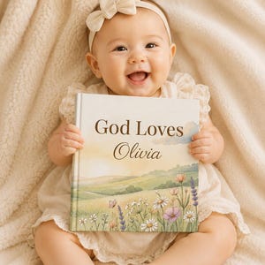 Könnte beinhalten: Ein gebundenes Buch mit dem Titel God Loves Olivia und einer Aquarellillustration einer grünen Hügellandschaft, Wildblumen und einem Schmetterling. Das Buchcover zeigt eine sanfte Farbpalette in Grün, Gelb und Rosa mit Text.