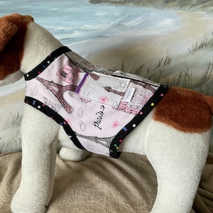 May include: A white ceramic mug with a black handle and the text "But first, coffee" in a handwritten style. The mug is on a white surface. The mug is likely for hot beverages.