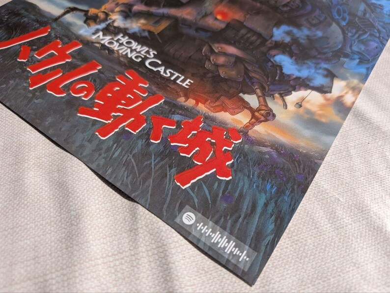 May include: A poster featuring the title "Howl's Moving Castle" in English and Japanese. The artwork depicts a fantastical castle with a sunset background. A Spotify code is visible in the lower right corner.