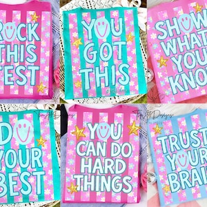 May include: A white ceramic mug with a black handle and the text "But First, Coffee" in a black, handwritten-style font. The mug is on a white surface.