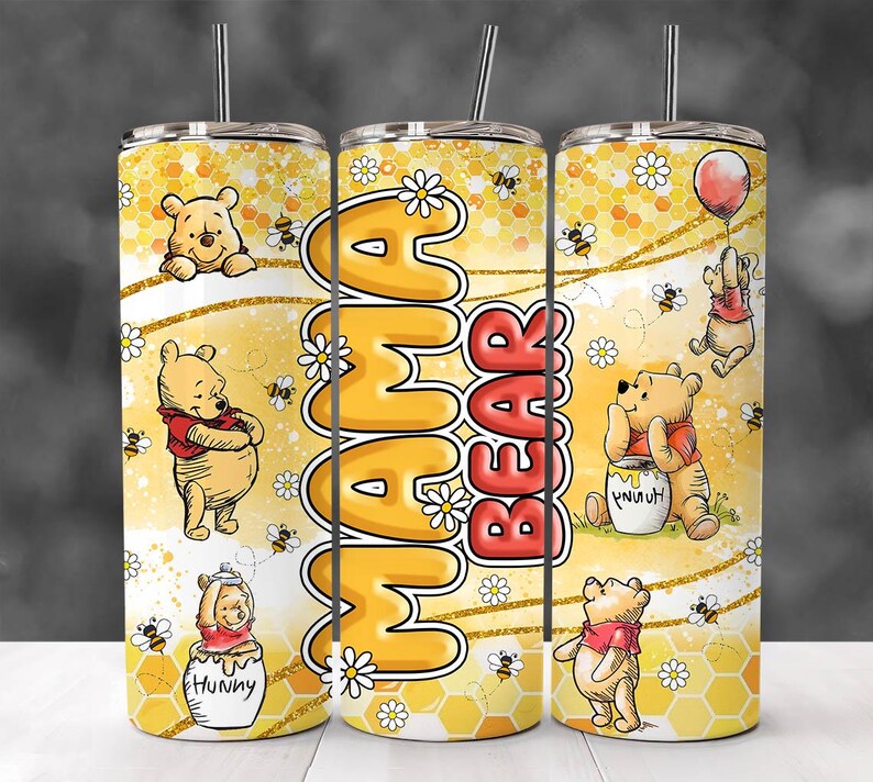 May include: A yellow and gold stainless steel tumbler with a Winnie the Pooh theme. The tumbler features a honeycomb pattern, daisies, and Winnie the Pooh characters. The text "Mama Bear" is printed on the tumbler.