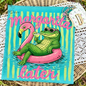 May include: A turquoise t-shirt with a flamingo float and an alligator wearing sunglasses, holding a margarita. The words "Margarita Later" are in pink script. The shirt has vertical stripes.