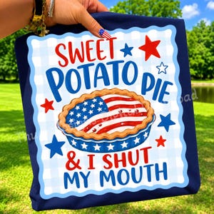 Könnte beinhalten: Marineblaues T-Shirt mit einem Grafikdesign, das einen Süßkartoffelkuchen mit der amerikanischen Flagge zeigt. Der Text lautet "SWEET POTATO PIE & I SHUT MY MOUTH" in Rot und Blau.