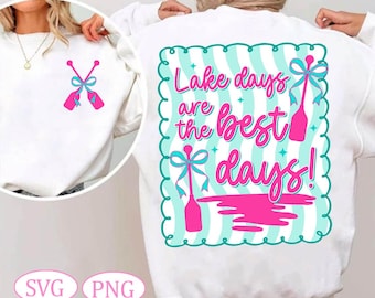 Op de afbeelding: Witte sweatshirt met een roze en turquoise design. De voorkant toont gekruiste roeispanen met strikken, terwijl de achterkant de zin "Lake days are the best days!" in roze script weergeeft, met roeispaan illustraties en een turquoise rand.