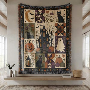 May include: A rectangular woven throw blanket featuring a multi-panel Halloween design. The imagery includes a haunted house, black cats, a ghost, pumpkins, a crescent moon, bats, lanterns, and geometric quilt patterns in orange, purple, and black.