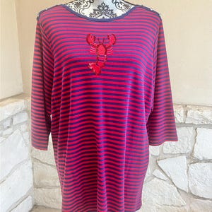 May include: A red and navy blue striped long-sleeve shirt with a sequined lobster design on the front. The shirt has a round neckline and is displayed on a mannequin.