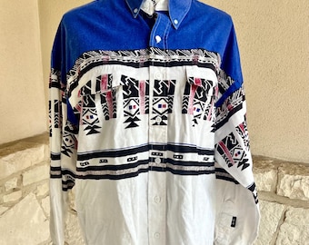 May include: A long-sleeved button-down shirt with a white background and a geometric pattern in black, red, and blue. The collar and top portion of the shirt are solid blue.