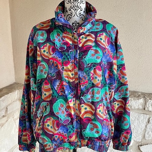 May include: A colorful vintage jacket with a zipper closure and a patterned design featuring abstract shapes in shades of green, blue, red, orange, and yellow.