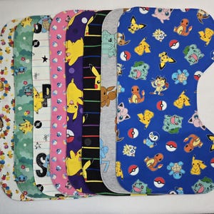 May include: Seven colorful fabric bibs with a Pokemon theme. The bibs feature various Pokemon characters, including Pikachu, Bulbasaur, Charmander, Squirtle, and more. The bibs are made of a soft, absorbent fabric and are perfect for keeping babies and toddlers clean during mealtime.