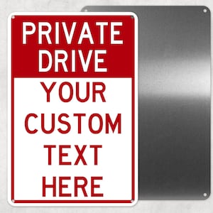 May include: A rectangular metal sign with a red top section and a white bottom section. The red section reads "PRIVATE DRIVE" in white capital letters. The white section reads "YOUR CUSTOM TEXT HERE" in red capital letters. A second, blank metal sign is next to it.